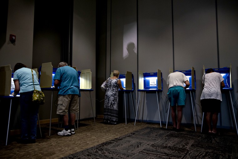 Image: Voters fill out ballots at a polling station in Janesville, Wisc., on Aug. 14, 2018.