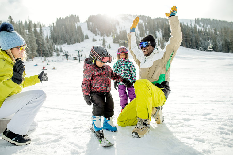 Image: Family having fun during the winter at a ski resort on a nice day.