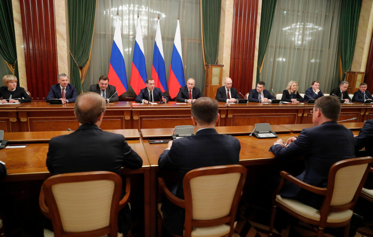 Image: Russian President Vladimir Putin, center, and Russian Prime Minister Dmitry Medvedev, center left, attend a cabinet meeting in Moscow
