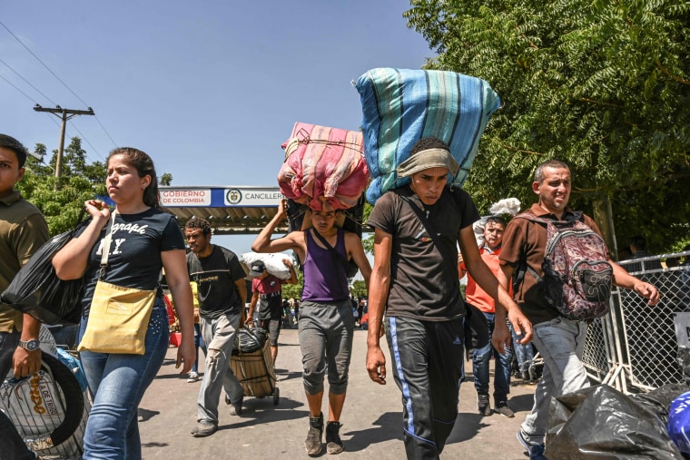 Venezuelans cross the Simon Bolivar International Bridge back to Venezuela after buying supplies in Colombia on Jan. 4, 2020.