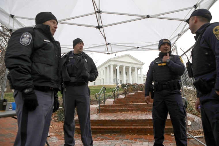 Law enforcement manage a security checkpoint to access the Virginia State Capitol grounds ahead of a gun rights advocates and militia members rally in Richmond, Virginia