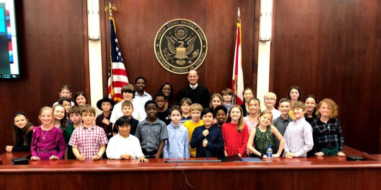 Small posed with her students and the judge for a photo after becoming an American citizen.