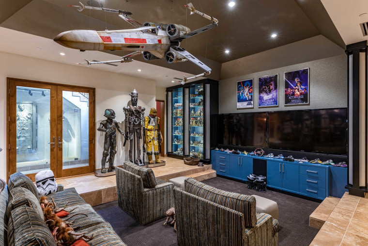 The replica X-wing Starfighter hangs above a lounge area.