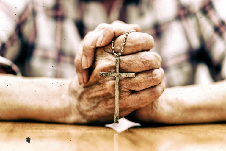 Image: Man holding cross