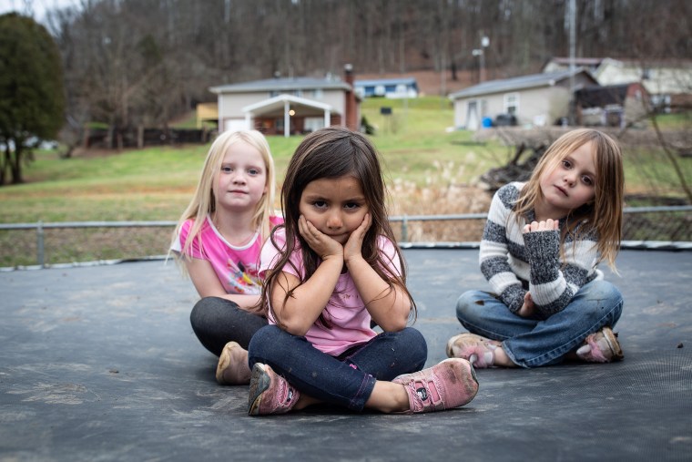 Nine-year-old Kristen, four-year-old Brynn and six-year-old Harlow pose on the trampoline in their backyard in Charleston, W.V. All three children were adopted from foster care, and were either born dependent on opioids, or exposed to the drugs in utero. The opioid epidemic has pushed thousands of West Virginian children into the foster care system. Today, more than 7,000 children are in state care, a 71 percent increase over the past decade.