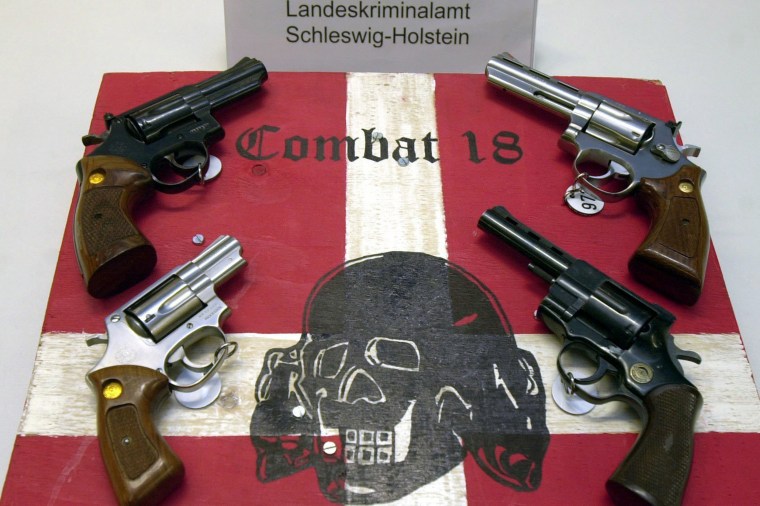 Image: Weapons and a sign of the neo-Nazi group Combat 18 seized by the police in Kiel, northern Germany.