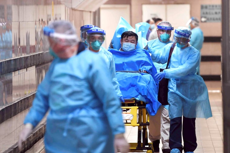 Image: Medical staff transfer a patient of a highly suspected case of a new coronavirus at the Queen Elizabeth Hospital in Hong Kong