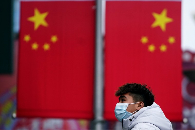 Image: A man wearing a mask is seen at the Nanjing Pedestrian Road, a main shopping area, in Shanghai