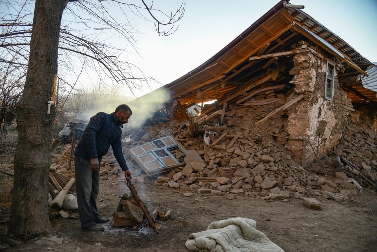 A villager stands by his collapsed house after an earthquake in Sivrice, near Elazig, eastern Turkey. 