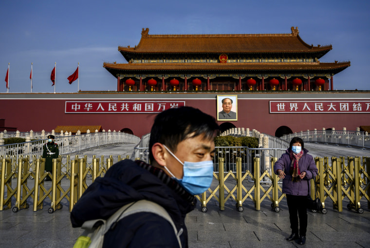 Image: A couple wears masks as they visit Tiananmen Gate in the midst of a coronavirus outbreak in Beijing on Jan. 24, 2020.