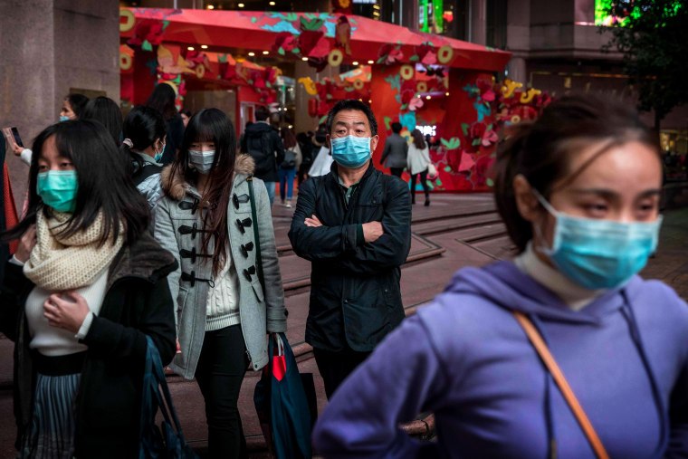 Image: People wear masks to protect against the coronavirus outbreak in Hong Kong on Jan. 26, 2020.