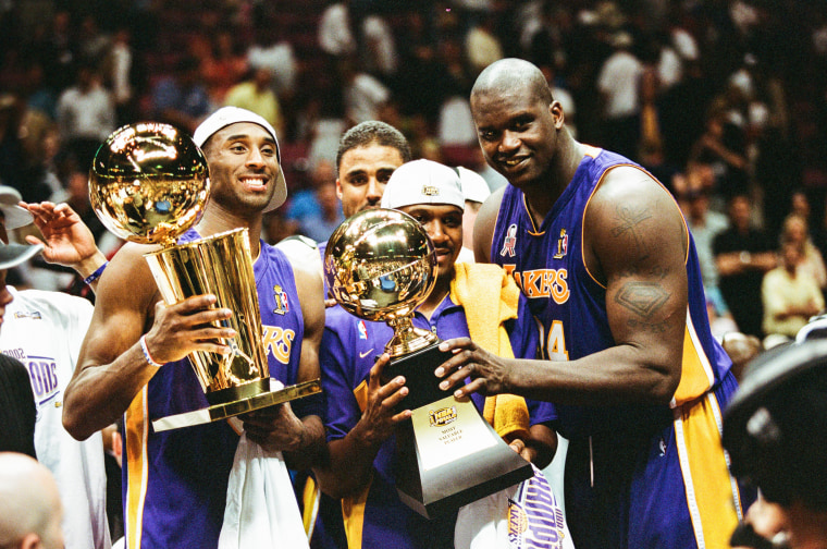 Image: Kobe Bryant, Lindsey Hunter, and Shaquille O'Neal celebrate after Game Four of the NBA Finals against the New Jersey Nets in 2002.