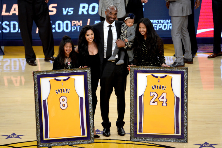 Image: Kobe Bryant poses with his family as both his Los Angeles Lakers numbers, 8 and 24, are retired at the Staples Center on Dec. 18, 2017.