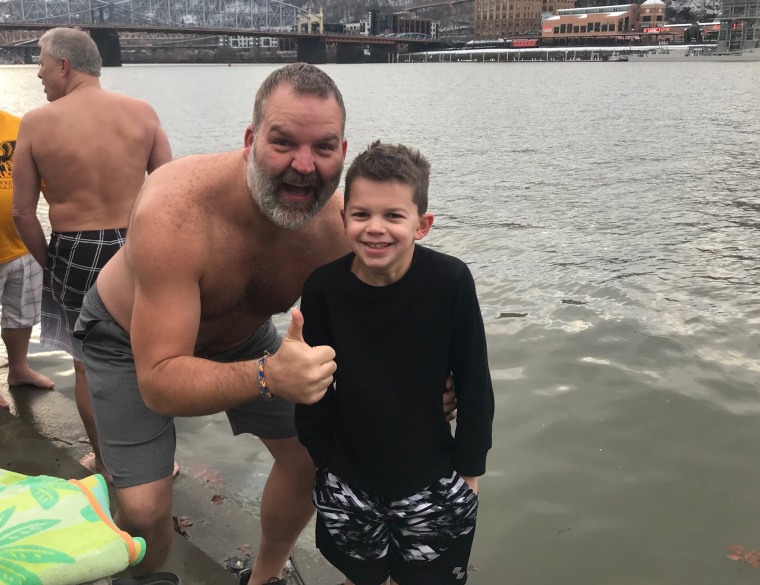 This year Brian Carothers' 8-year-old son, Cy, joined him for a polar bear plunge. Cy rushed out faster than Carothers thought possible because the boy couldn't stand the frigid water. 