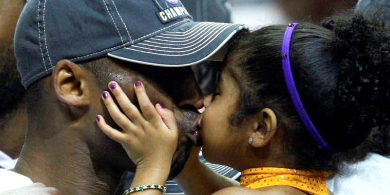 Image: FILE PHOTO: Los Angeles Lakers Kobe Bryant kisses his daughter Gianna after they defeated the Orlando Magic to win the NBA basketball championship in Orlando