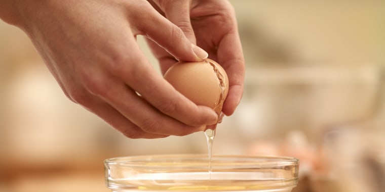 Woman cracking egg