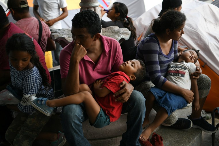 Image: Honduran asylum seekers sent back to Mexico from the U.S. under Migrant Protection Protocols (MPP) pass the time at a makeshift encampment in Matamoros