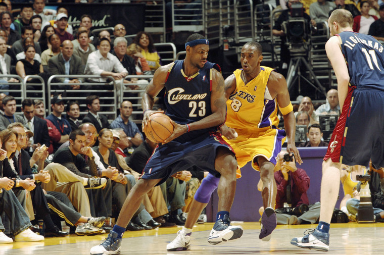 Lebron James drives to the hoop against Kobe Bryant in Los Angeles