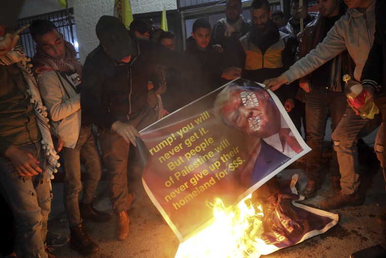 Image: Palestinians burn a poster 