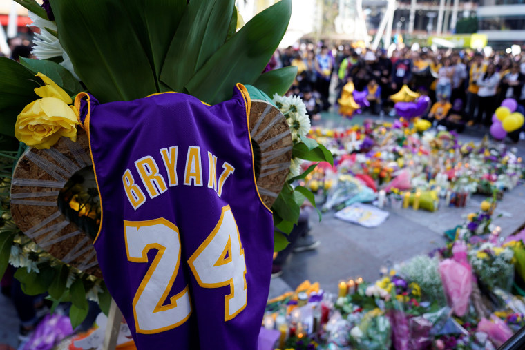 Image: Fans of NBA basketball star Kobe Bryant pay their respects at a memorial outside the Staples Center at L.A. Live in Los Angeles