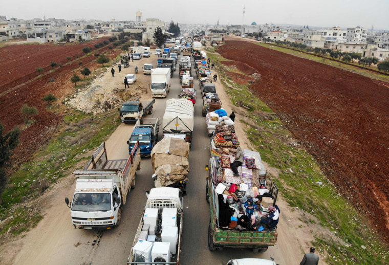 Image: Displaced Syrians driving through Hazano in the northern province of Idlib on Jan. 28, 2020.