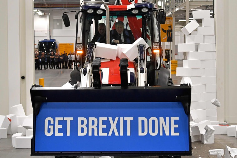 Image: Prime Minister Boris Johnson drives a Union flag-themed excavator with the words "Get Brexit Done," during the election campaign event in December 2019.