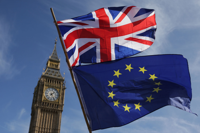 Image: An EU flag and a Union flag held by a demonstrator is seen with Elizabeth Tower (Big Ben) and the Houses of Parliament as marchers taking part in an anti-Brexit, pro-European Union (EU) in central London