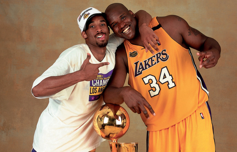Image: Kobe Bryant and Shaquille O'Neal of the Los Angeles Lakers pose with the NBA Championship trophy at the Staples Center in 2000.