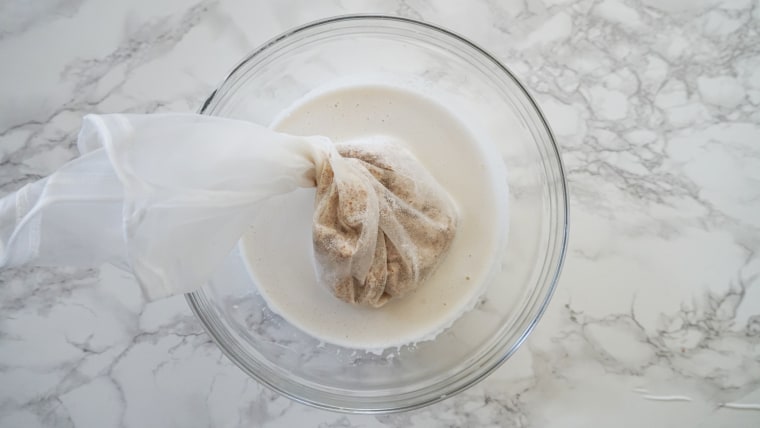 After the nut milk is blending, strain out the leftover pulp.