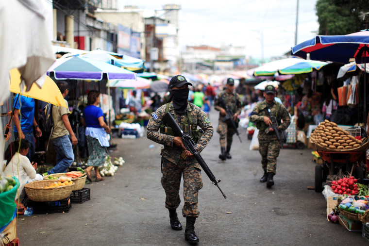 Image: Salvadoran soldiers patrol in downtown San Salvador after six market sellers were killed in San Salvador