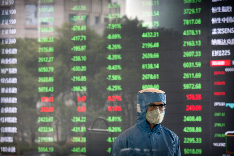 Image: A worker wearing a protective suit inside the lobby of the Shanghai Stock Exchange on Feb. 3, 2020.