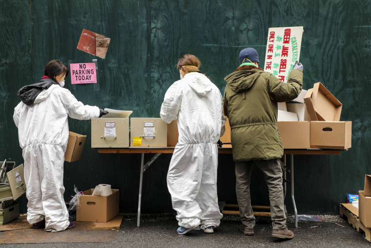 Staff and volunteers of The Museum of Chinese of America re-box recovered items from the collections and research center that had been water damaged after putting out the fire, on Jan. 31, 2020.