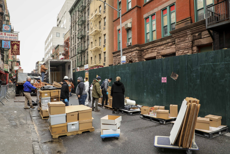 Staff and city workers repacked wet and damaged items outside of 70 Mulberry street and packed them onto pallets and into trucks to be transported for recovery efforts, on Jan. 31, 2020.