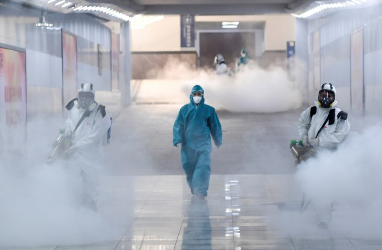 Image: Volunteers in protective suits disinfect a railway station as the country is hit by an outbreak of the new coronavirus, in Changsha, Hunan province, China
