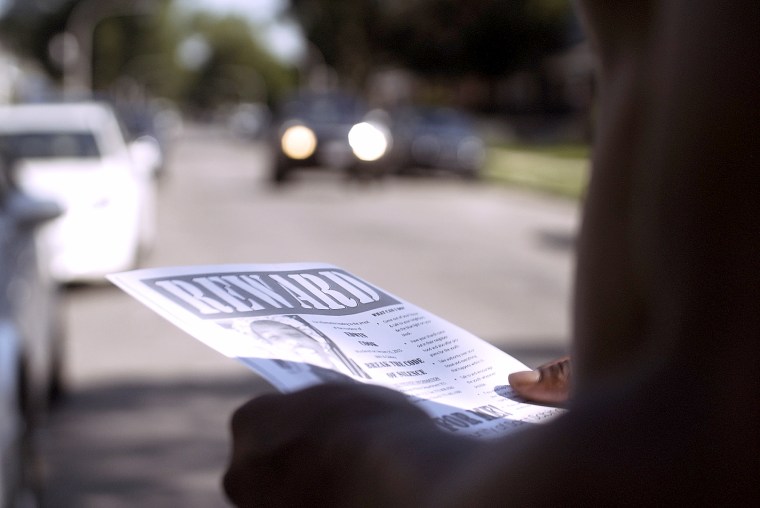 A member of the community holds Edwin Cook's reward flyer that was handed out by his aunt in hopes of finding the person who murdered her nephew and left the case unsolved.