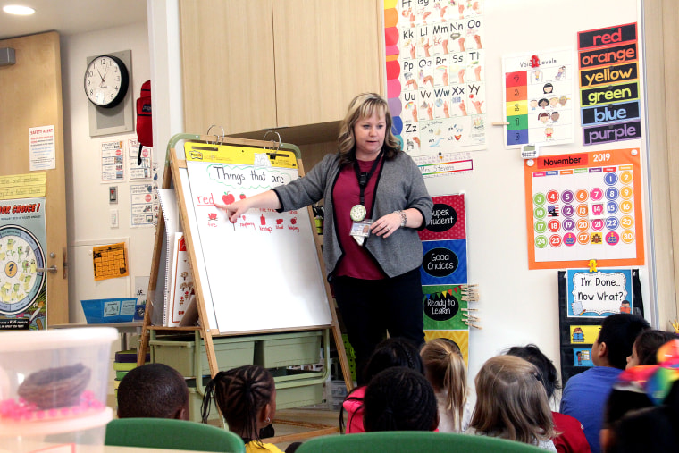 Sara Stevens teaches a lesson to her kindergartners. While students have lots of time to play, they also learn traditional and rigorous academic material.