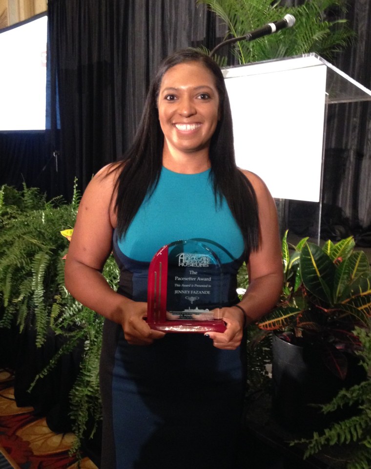Fazande poses with her Pace Setter Award, which she won in 2017 from the Association of African American Museums.