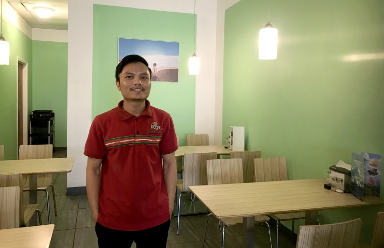 Suan Mang stands inside his restaurant Zogam Cafe in Tulsa, Okla.