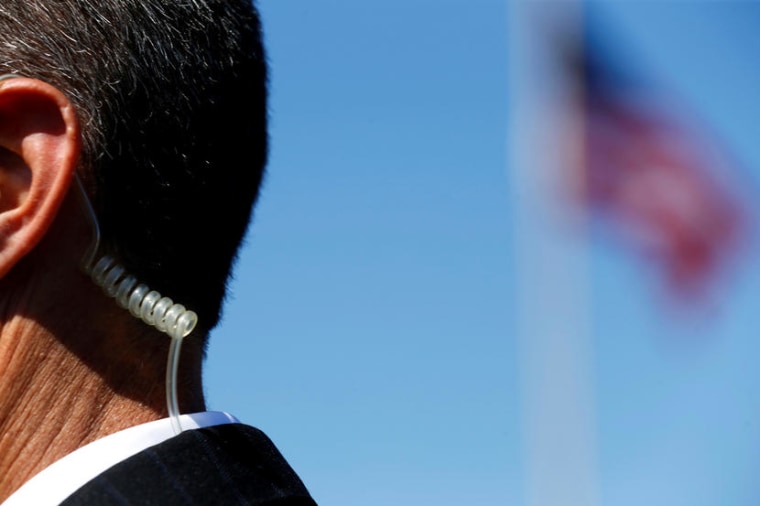 A secret service agent keeps a watch on U.S. Democratic presidential candidate Bernie Sanders during a rally in Vista, California