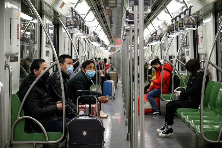 Image: Masked travelers in Shanghai