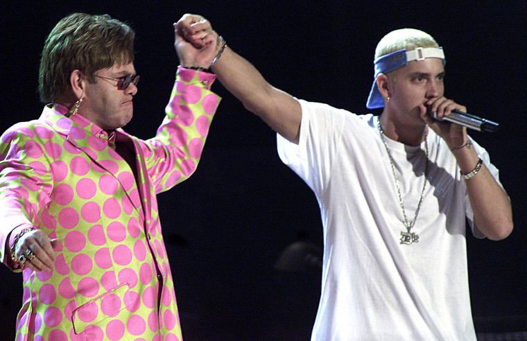 Elton John (L) joins rap musician Eminem (R) durin