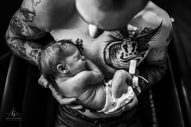Lindsey Ellis captured this image of Luke Halvorson holding his newborn son, Kamden. On Halvorson's chest is a tattoo honoring his son, Keegan, who died in utero in 2018 from a chromosome disorder.