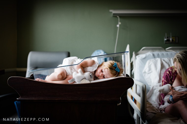 Florida photographer Natalie Zepp captured this image of a 2-year-old girl pretending to be the baby in her newborn sister's hospital bassinet.