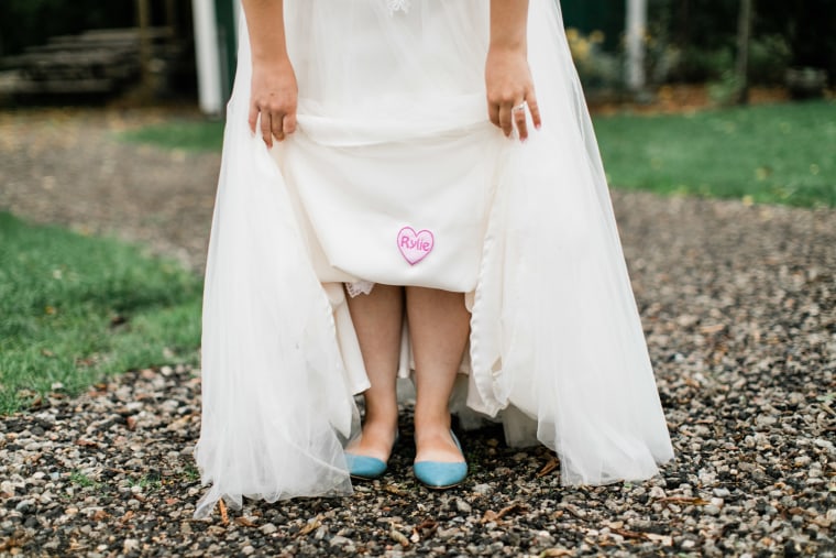 Dean's tailor sewed a heart-shaped patch, made from Rylie's baby blanket, into the inside of her wedding gown.
