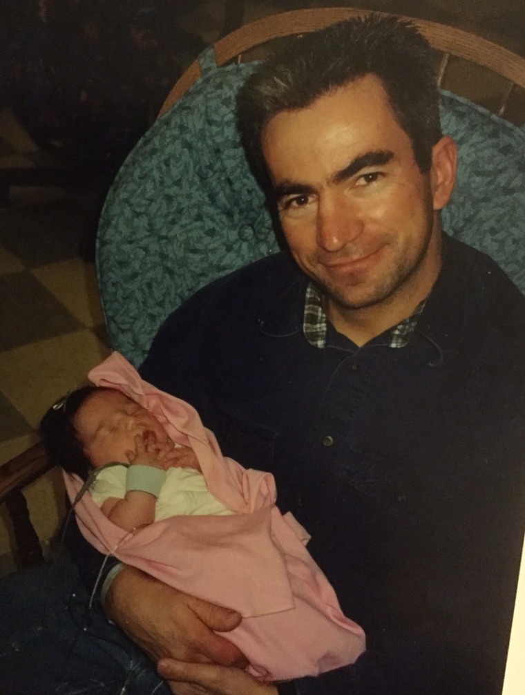 John Slama in 2001, holding his daughter, Rylie.