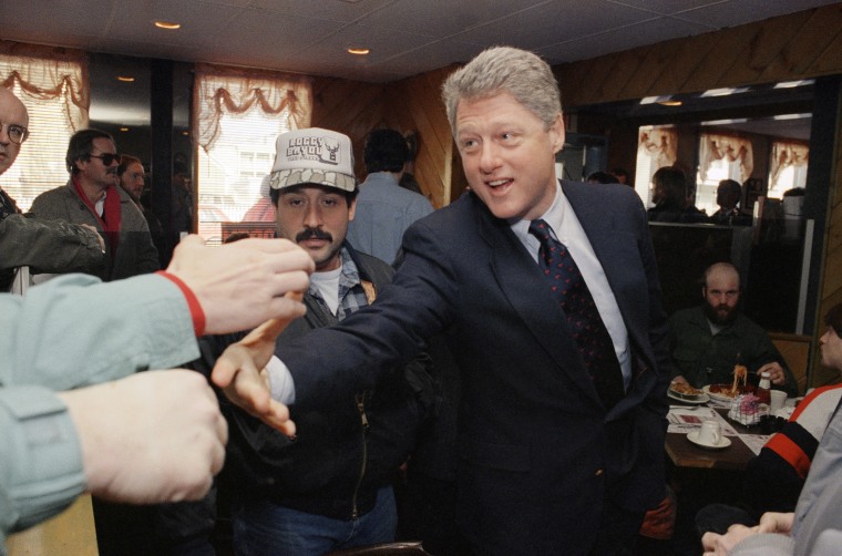 Democratic presidential hopeful Bill Clinton reaches for support while on a campaign stop in Manchester, N.H., on Feb. 13, 1992.