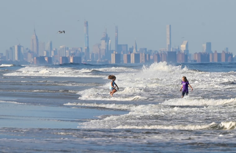 Children jump in the waves on the beach in Long Branch, New Jersey, on Sept. 17, 2019.