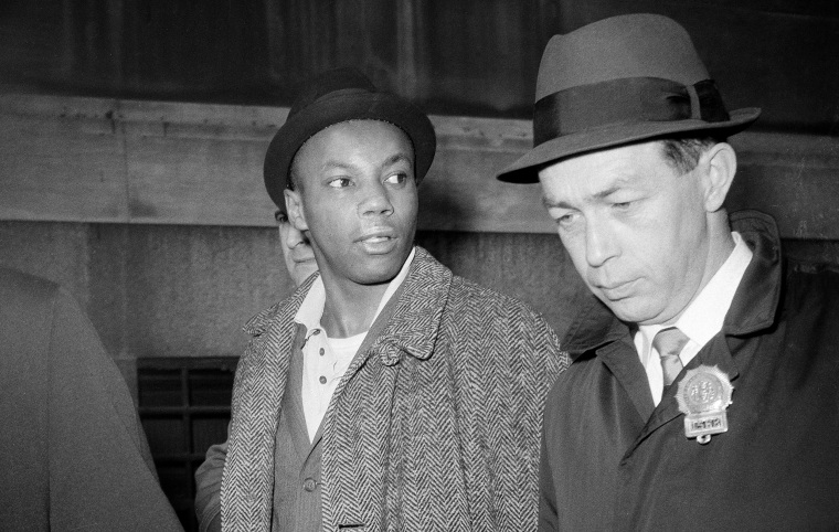 Image: Muhammad Abdul Aziz is escorted by detectives after his arrest in New York on Feb. 26, 1965.