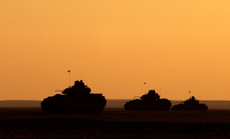 Image: U.S. Army Bradley Fighting Vehicles at sunset in Iraq in 2003.