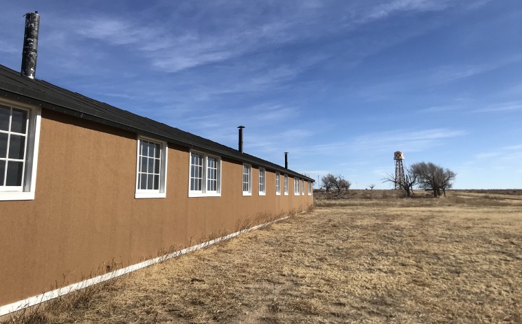 Historic recreations of a guard tower and barracks at Amache.